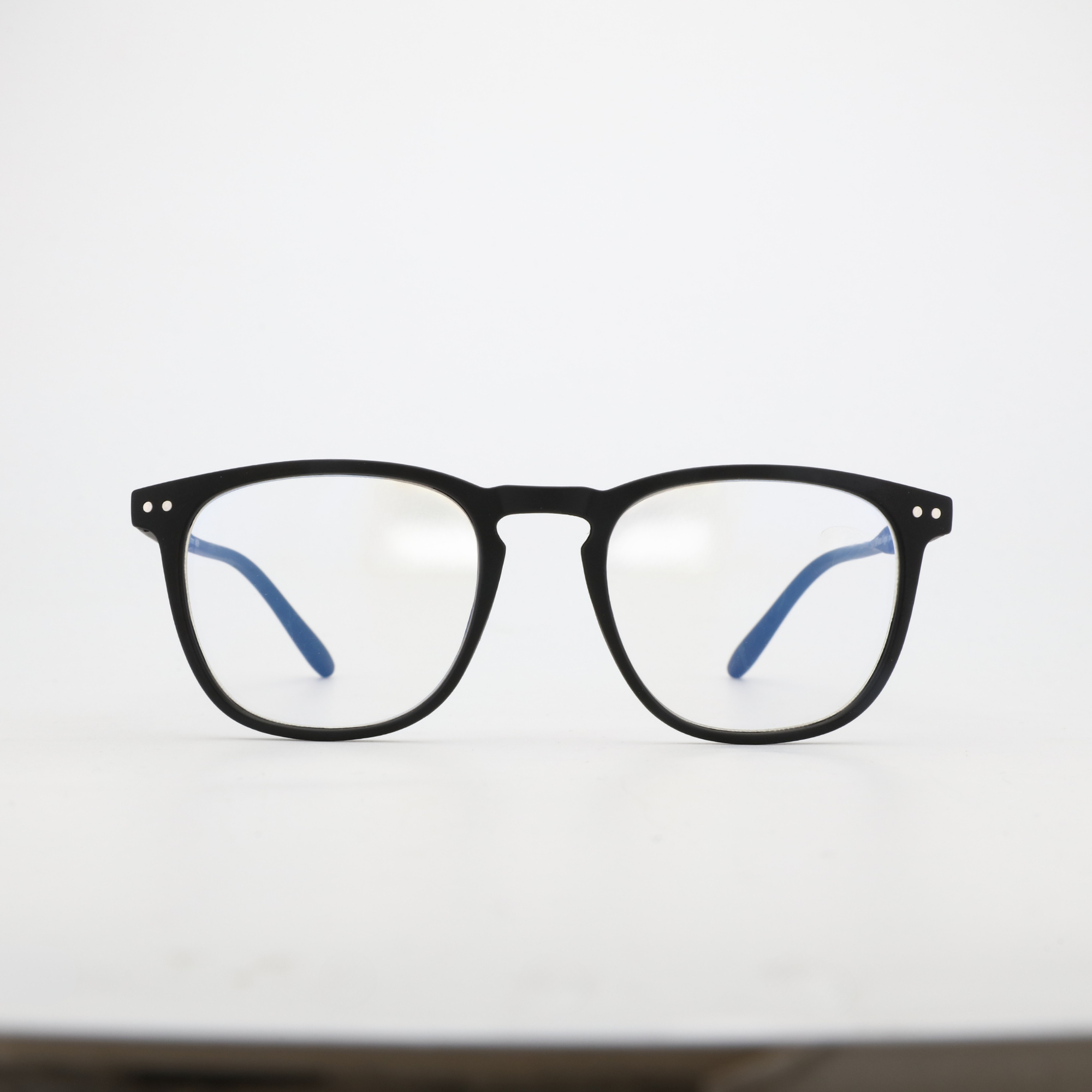 Frontansicht NightHaven Blaulichtfilterbrille VESPER™ Crystal Clear – mattschwarz mit klaren Gläsern und blauem Blaulichtfilter-Reflex, modernes Wayfarer-Design